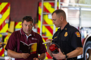 Firefighters with a fire extinguisher