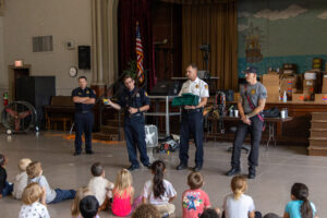 Firefighters talk to children