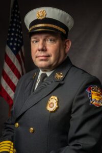 Jack Spencer dressed in Fire Chief uniform