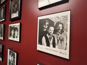 A wall covered in portraits of famous performers. 