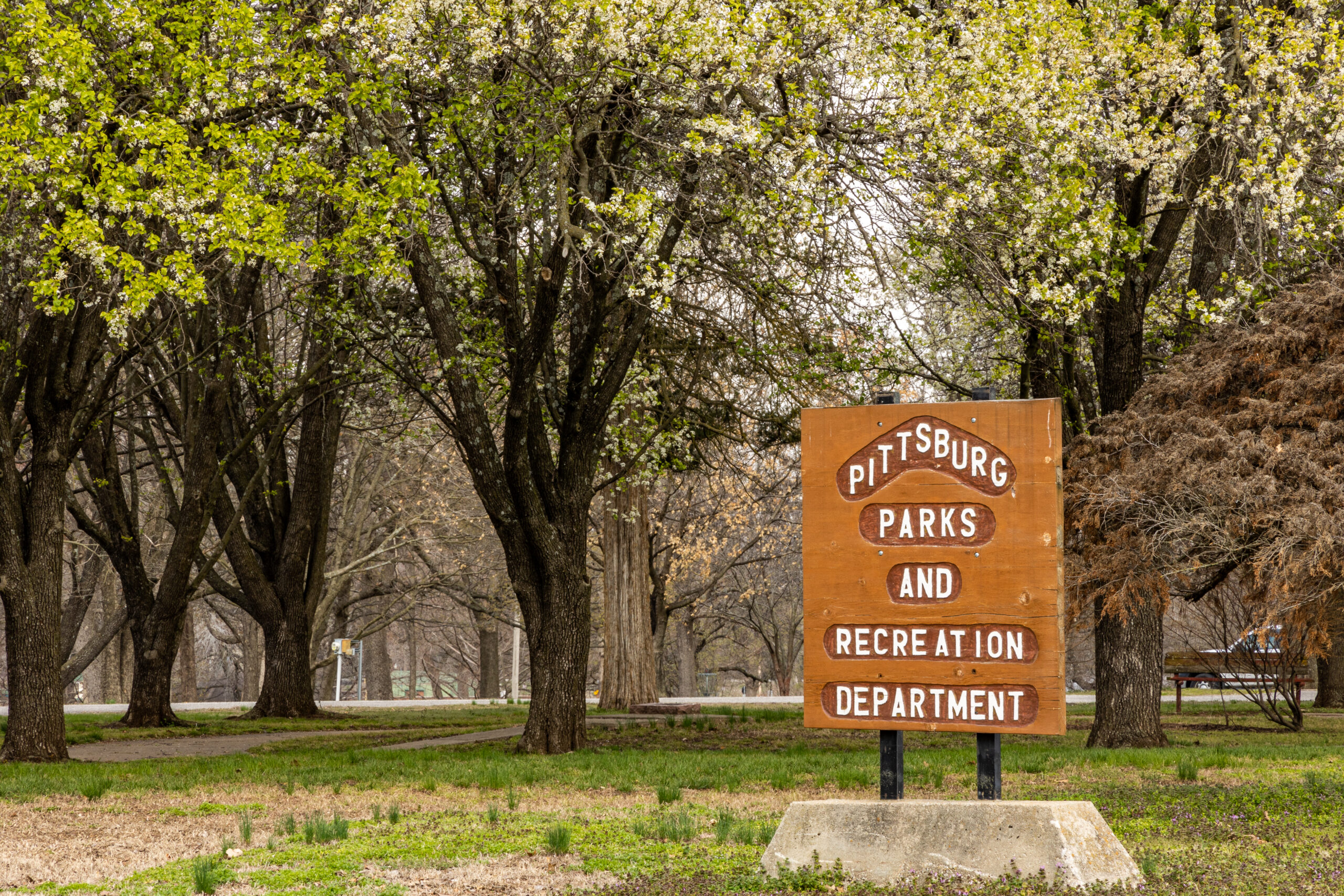 Lincoln Park Sign surrounded by trees in spring