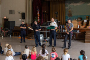 Firefighters talk to children