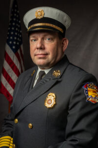 Jack Spencer dressed in Fire Chief uniform