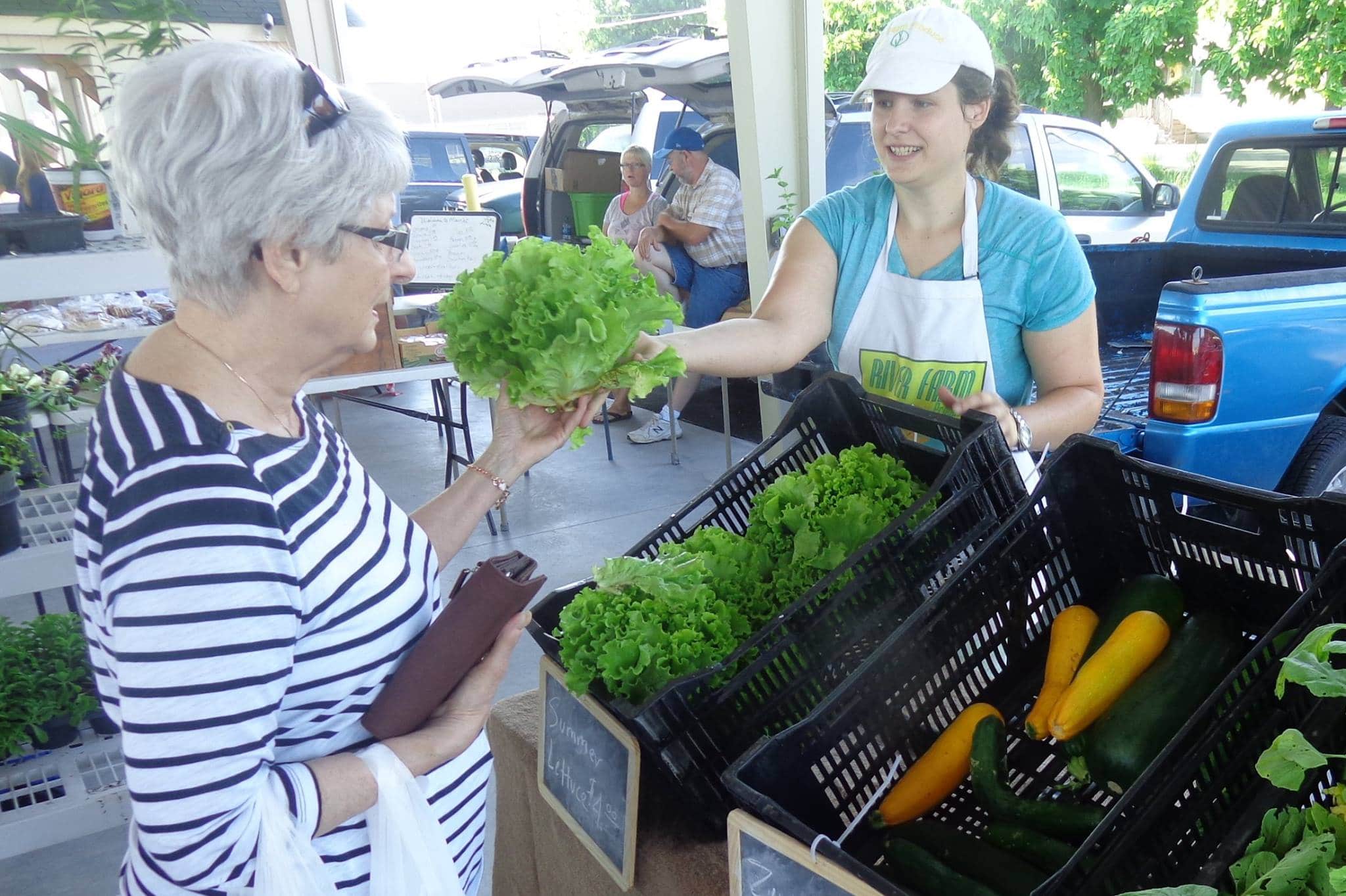 Farmer selling greens at the Pittsburg Farmers Market in Pittsburg, KS.