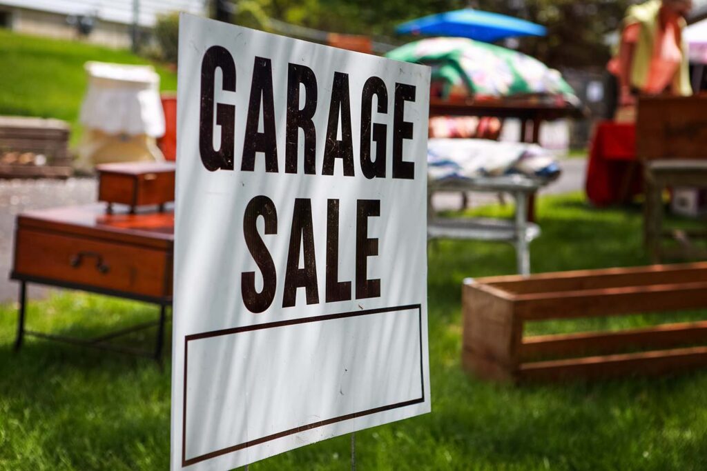 Garage sale sign on the lawn of a home