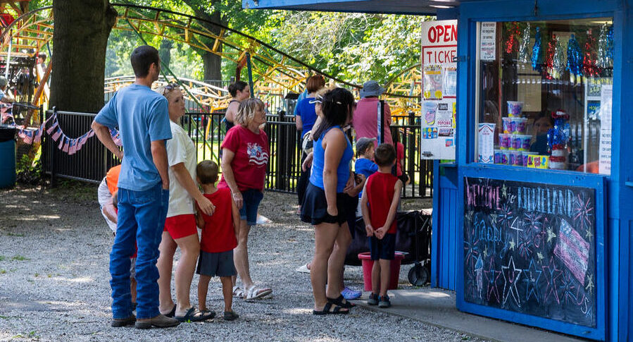Group of people standing at a ticket stand waiting to purchase tickets at Kiddieland in Pittsburg, KS