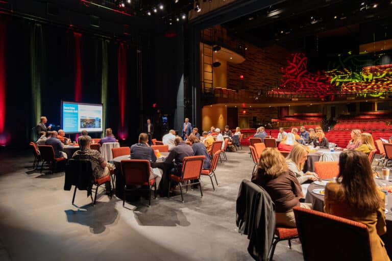 Leadership Kansas participants eat breakfast on the stage of the Bicknell Family Center for the Arts in Pittsburg, KS
